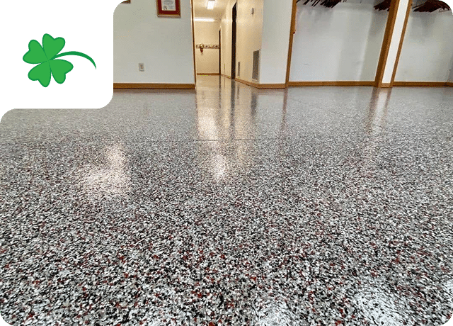 Polished flake floor hallway showcasing Sullivan's Concrete Coatings warranty-backed installation