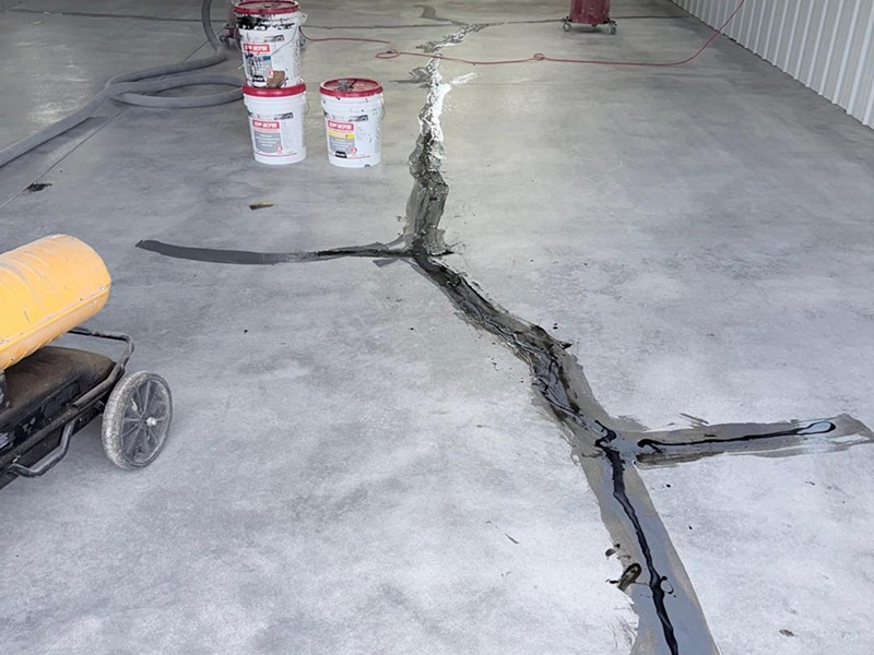 Garage floor crack repair in progress in Salem, Indiana by Sullivan's Concrete Coatings