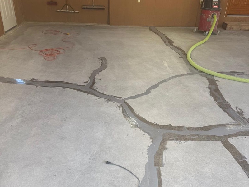 Garage floor crack repair in progress in Louisville, Kentucky by Sullivan's Concrete Coatings